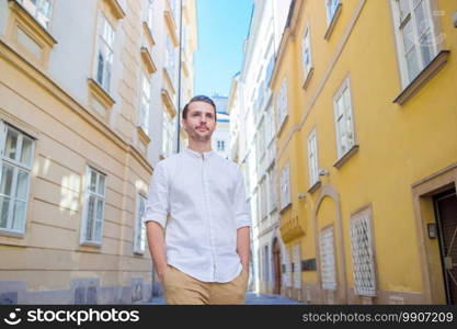 Young man portrait on old street in Vienna, Austria. Young man background the old european city take selfie