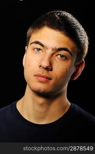 Young man portrait over black background