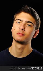 Young man portrait over black background