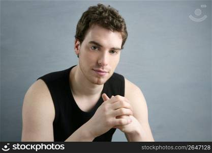 young man portrait posing looking camera over gray background