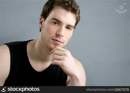 young man portrait posing looking camera over gray background