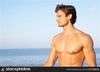 Young man poses on beach