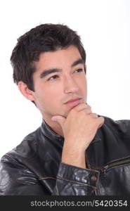 Young man posing in a leather biker jacket
