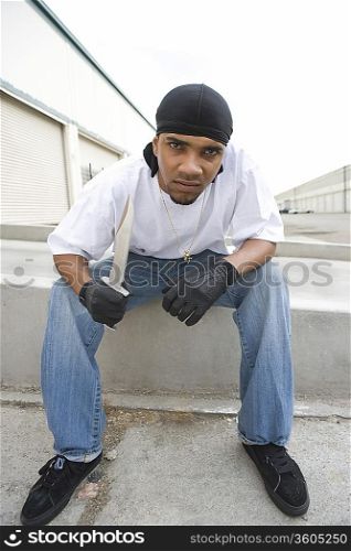Young man posing with knife