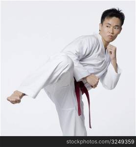 Young man practicing side kick