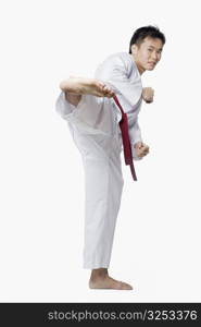 Young man practicing side kick