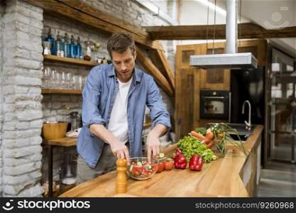 Young man preparing food in the rustic kitchen
