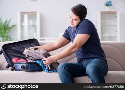 Young man preparing packing for summer vacation