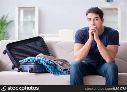 Young man preparing packing for summer vacation