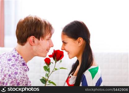 Young man presenting a flower to his girlfriend&#xA;