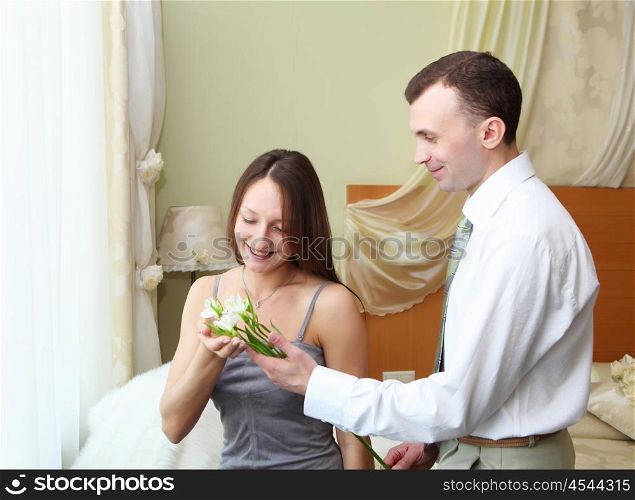 young man presenting flower to a young woman