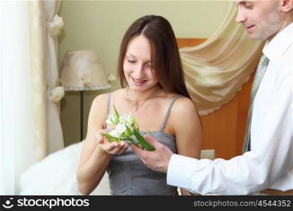 young man presenting flower to a young woman