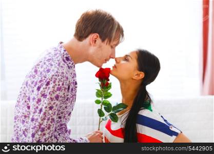 Young man presenting red rose to her girlfriend&#xA;