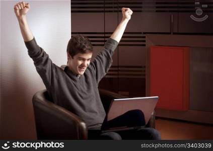 Young man raising his hands in victory