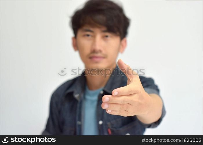 Young man reaching out for a handshake. selective focus