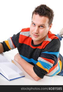 young man reading a book or studying on the floor isolated on white