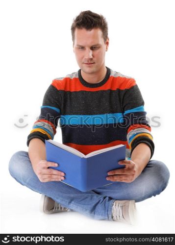 young man reading a book or studying on the floor isolated on white