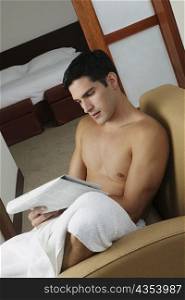 Young man reading a newspaper