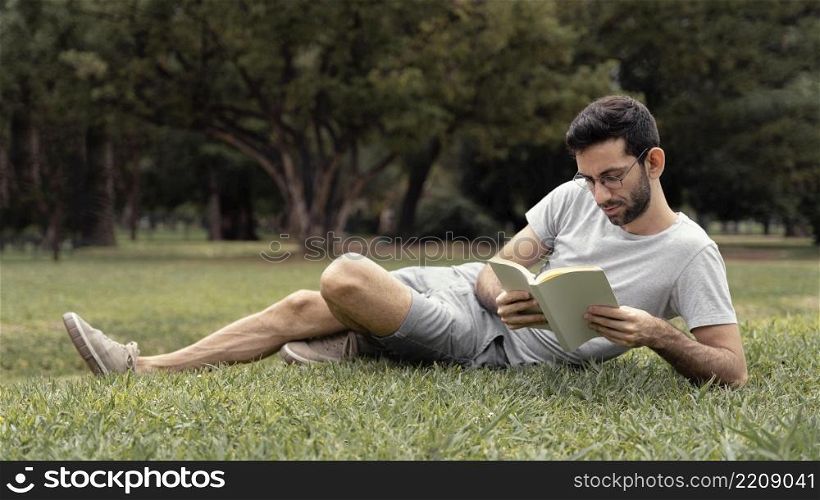 young man reading interesting book