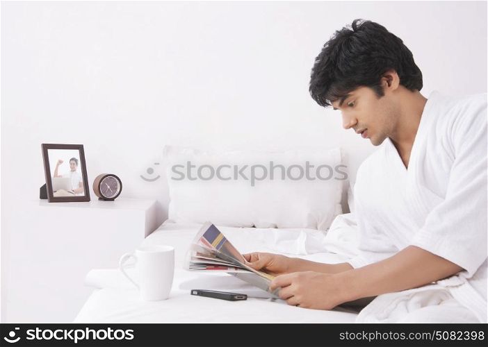 Young man reading newspaper