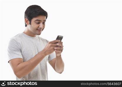 Young man reading text message and smiling