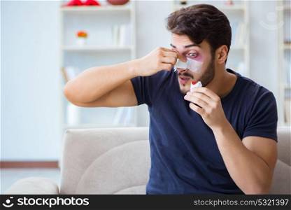 Young man recovering healing at home after plastic surgery nose . Young man recovering healing at home after plastic surgery nose job