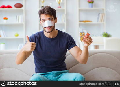 Young man recovering healing at home after plastic surgery nose . Young man recovering healing at home after plastic surgery nose job