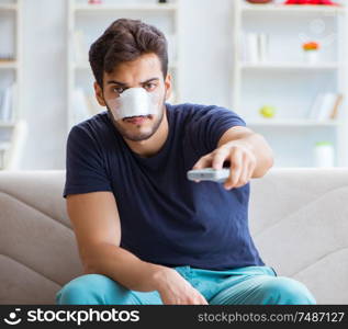 Young man recovering healing at home after plastic surgery nose job. Young man recovering healing at home after plastic surgery nose