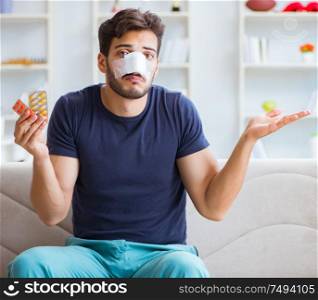 Young man recovering healing at home after plastic surgery nose job. Young man recovering healing at home after plastic surgery nose