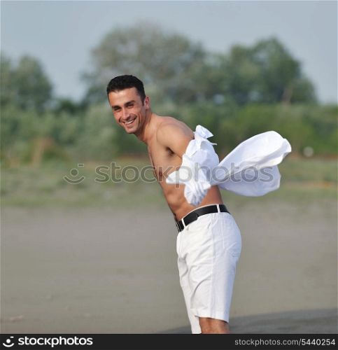 young man relax and have fun on beach at summer time