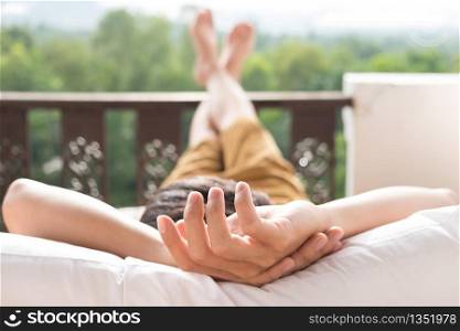 Young man relax on bed and enjoying mountain view.. Young man relax on bed and enjoying mountain view