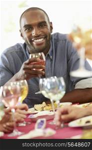 Young Man Relaxing At Dinner Party