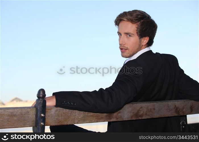 Young man relaxing on a bench