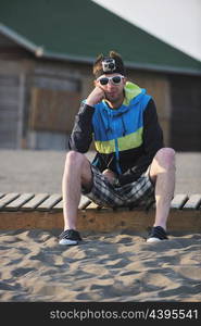 young man relaxing on beach at sunset