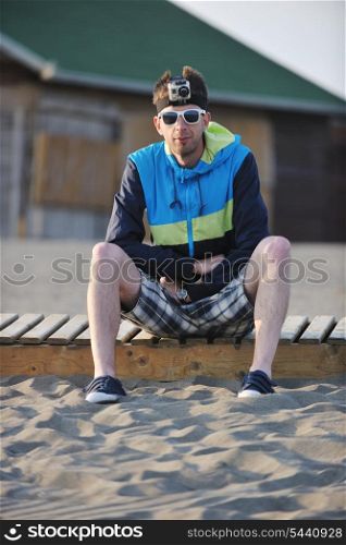 young man relaxing on beach at sunset