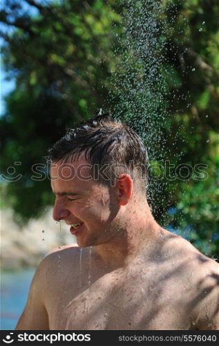 young man relaxing under shower