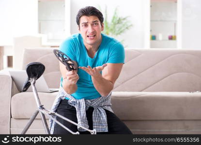 Young man repairing bicycle at home