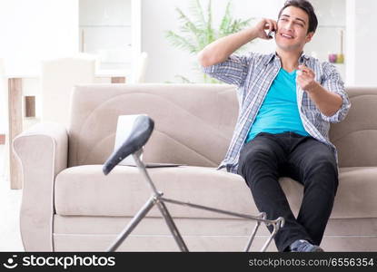 Young man repairing bicycle at home