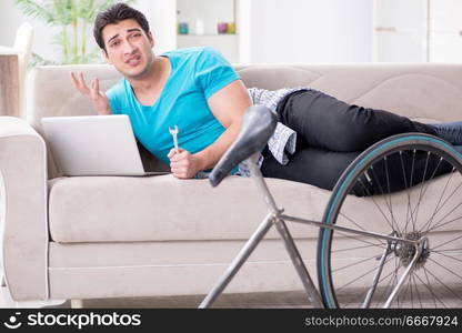 Young man repairing bicycle at home