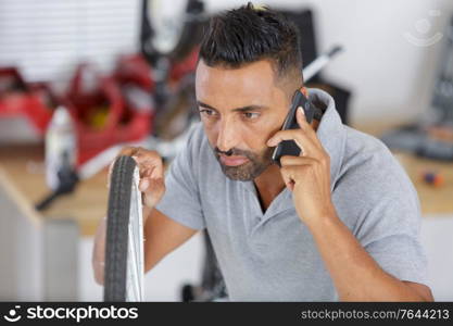 young man repairing bicycle at home