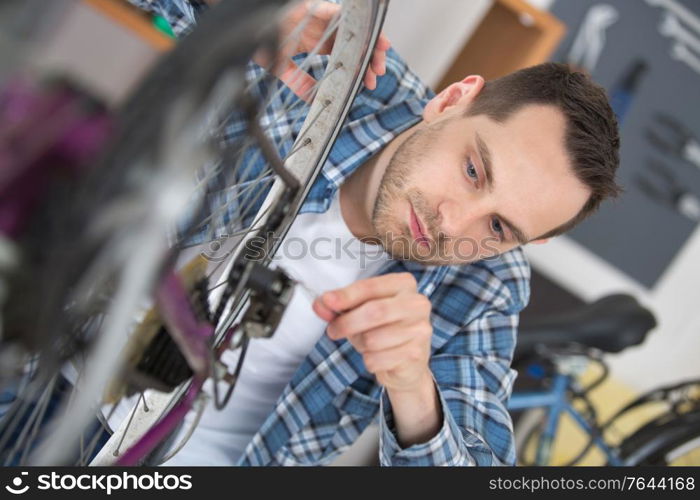 young man repairing bike