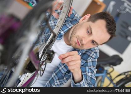 young man repairing bike