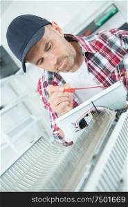young man repairing radiator