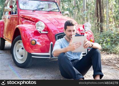 Young man resting at car trip by the countryside