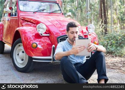 Young man resting at car trip by the countryside