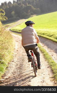 Young man rides his bike in park