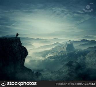 Young man riding a wild horse on the peak of a cliff. New lands discovery, adventure and friendship concept.
