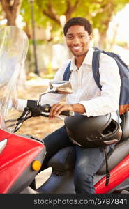 Young Man Riding Motor Scooter To Work