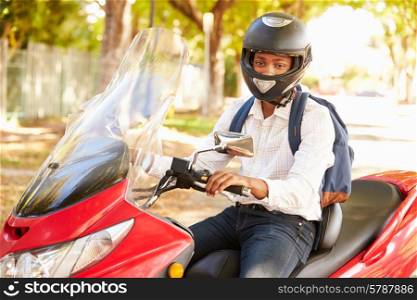 Young Man Riding Motor Scooter To Work