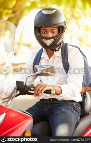 Young Man Riding Motor Scooter To Work